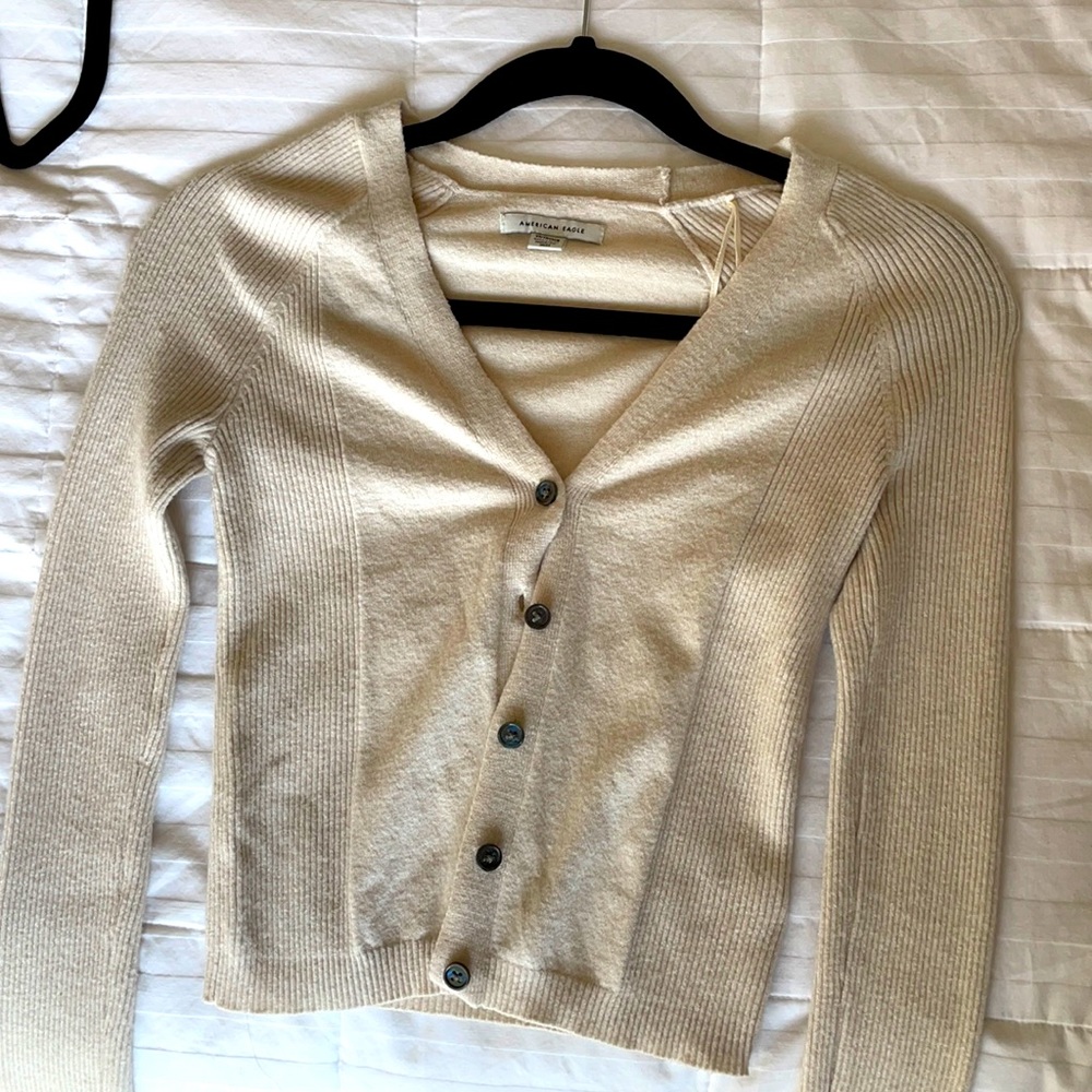 cream colored v neck shirt